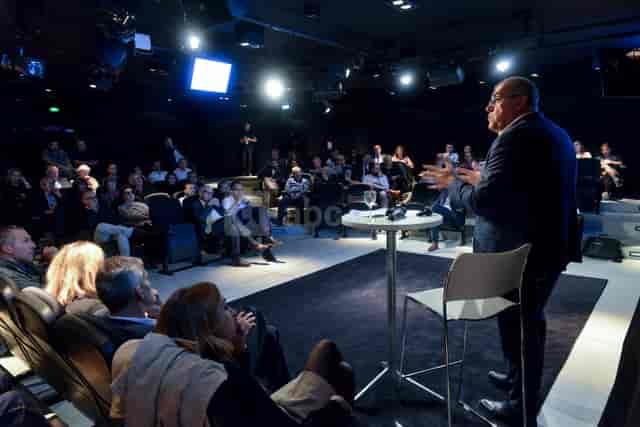 Grand Auditorium event with engaged audience and speaker in modern Musée des Confluences.