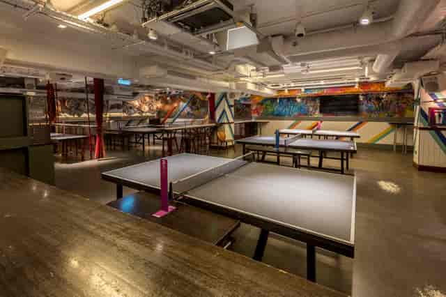 Vibrant event space with ping pong tables for networking in Shoreditch, London.
