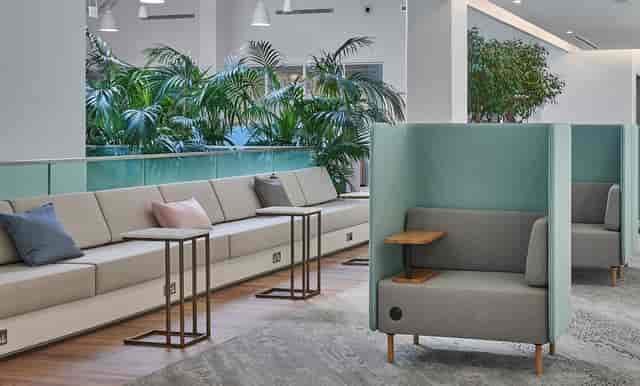 Modern co-working lounge with comfortable seating for informal meetings and networking.