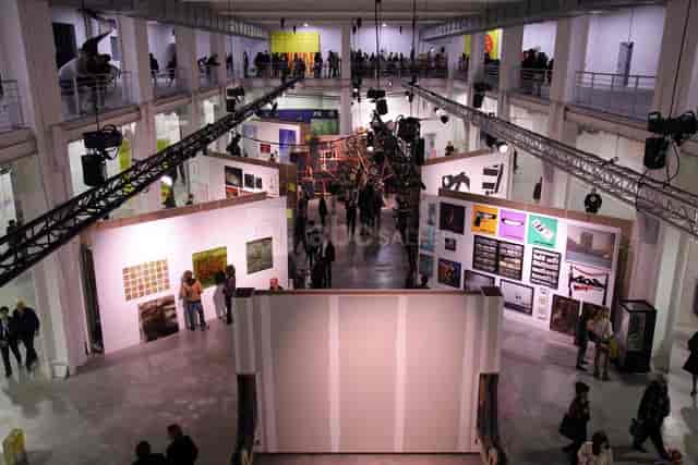 Espace Expositions in La Sucrière, featuring diverse artworks and high industrial ceilings.