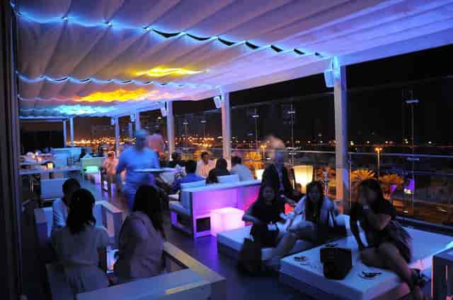 Vibrant rooftop lounge at HUES Boutique Hotel, perfect for evening events and gatherings.