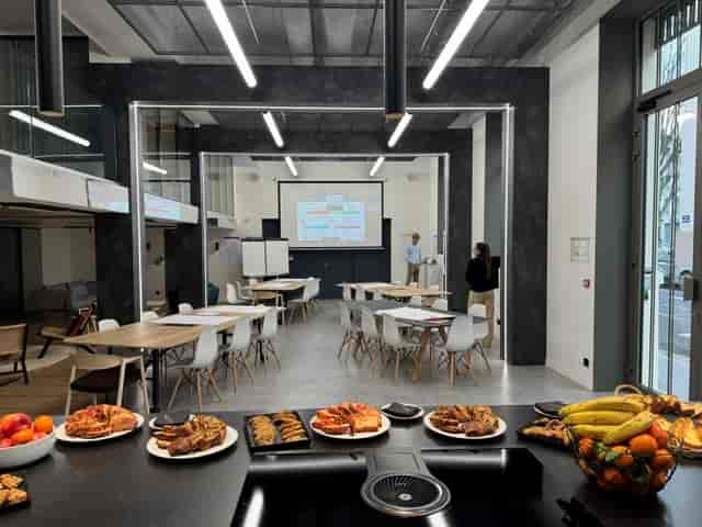 Modern conference room with seating and presentation screen for corporate events.