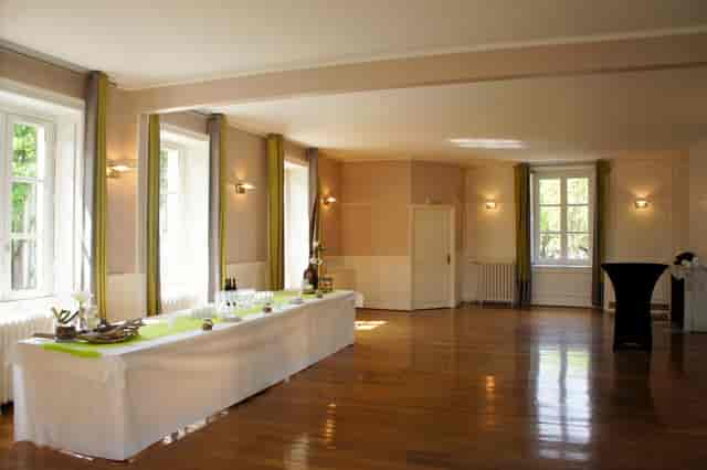 Banquet hall at Château de Montchat with elegant wooden floor for gatherings and meetings.