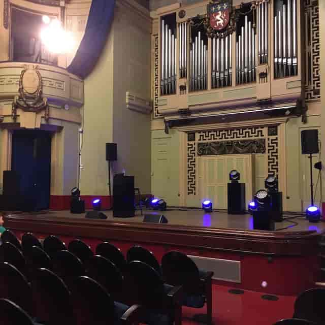 Salle Molière stage with audiovisual equipment, ideal for dynamic events and performances.