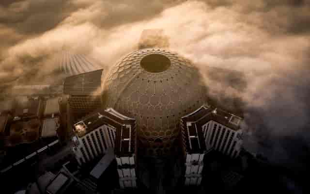 Aerial view of Al Wasl Plaza dome in fog, ideal for unique conferences and events.