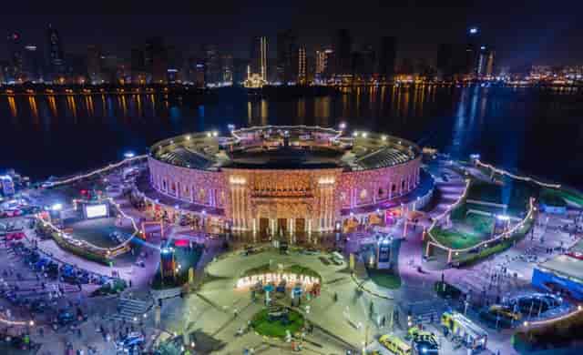 Vibrant Al Majaz Amphitheatre at night, ideal for concerts and festivals.
