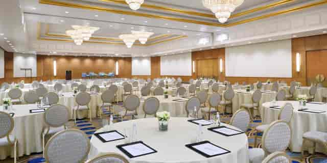Elegant wedding hall at Kingdom Centre with round tables, perfect for conferences and gala dinners.