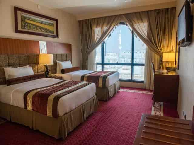Al Safwah Hotel suite with twin beds, ideal for conference attendees and events.