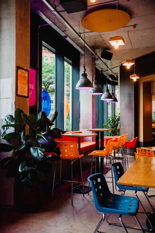 Vibrant restaurant meeting space with colorful seating for casual brainstorming sessions.