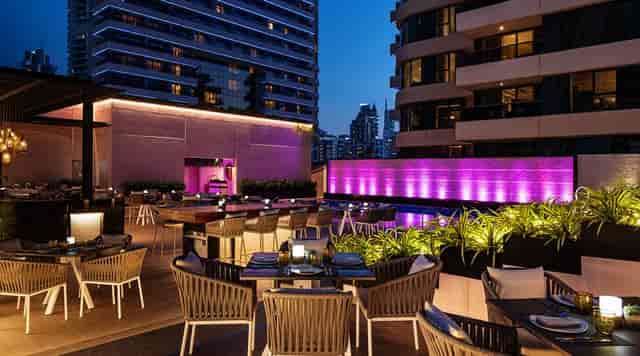 Rooftop restaurant in Buddha-Bar Dubai, vibrant purple lights for events and celebrations.