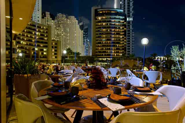 Elegant outdoor dining at Zengo with a stunning city skyline, ideal for evening events.