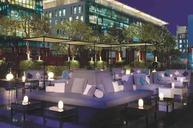 Stylish outdoor lounge at Ritz-Carlton Dubai, perfect for networking and gatherings.