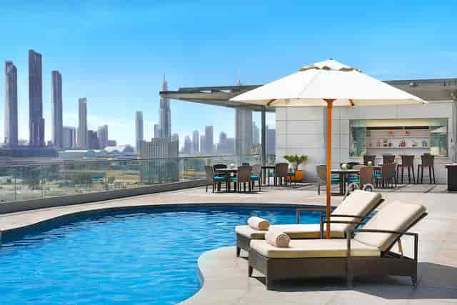 "Rooftop pool at Olive Garden, Ritz-Carlton Dubai, ideal for events and networking."