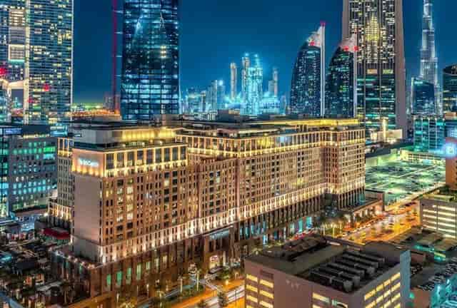 Ritz-Carlton Dubai Gala: Luxurious hotel with vibrant skyline, perfect for corporate events.