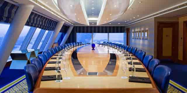 Suha Boardroom at Jumeirah Burj Al Arab, sleek table, luxury meetings and presentations.