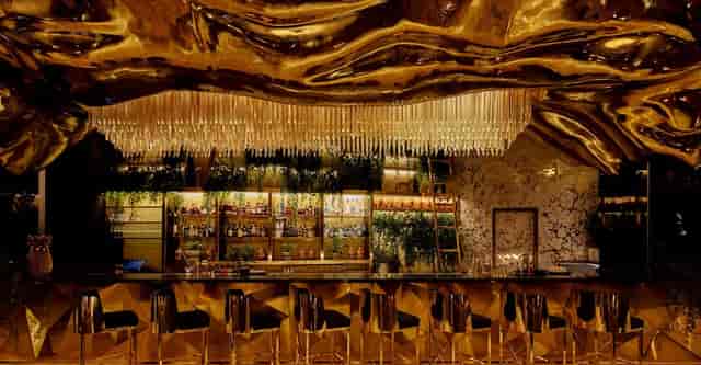 Luxurious Gilt bar in Jumeirah Burj Al Arab with golden ceiling for cocktail parties.