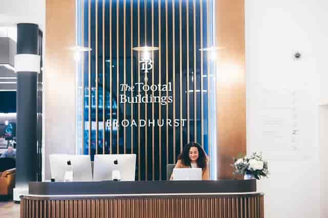 Modern serviced offices reception area with warm wood accents, ideal for professional events.