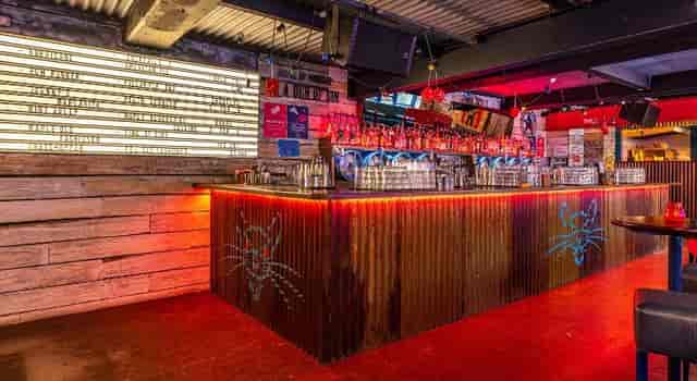 Vibrant Mean Eyed Cat Bar with neon lights for casual networking and social events.