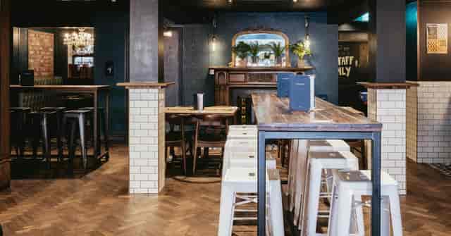 "Versatile event space with high tables at Bay Horse Tavern for gatherings and meetings."