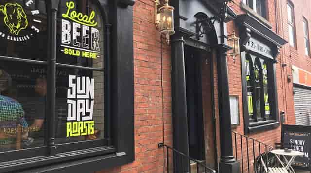 Bar & grill at The Bay Horse Tavern with inviting signage for local beer and Sunday roasts.