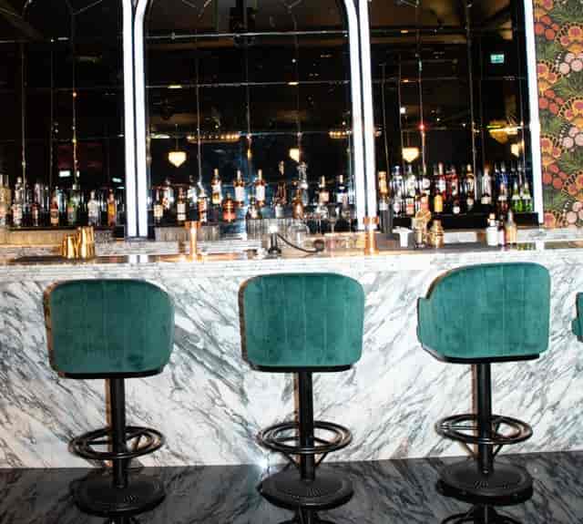 Stylish Soho Garden bar with marble countertop, ideal for cocktail receptions and networking.