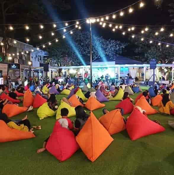 Vibrant outdoor event at Area Ring O with colorful bean bags and live music.