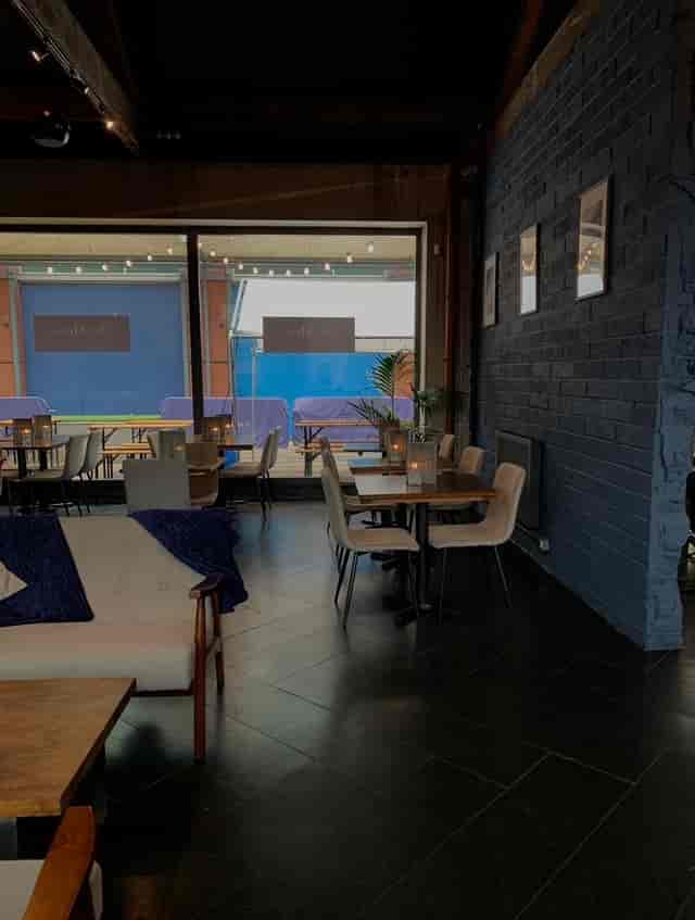 Outdoor terrace event space with cozy decor and natural light for intimate gatherings.