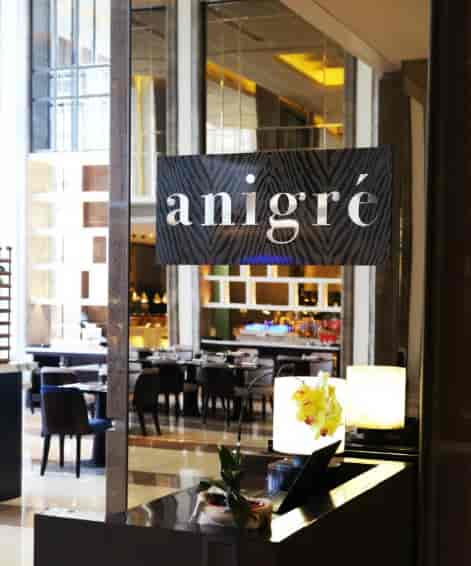 Modern dining area in Anigré restaurant; ideal for corporate events and special occasions.