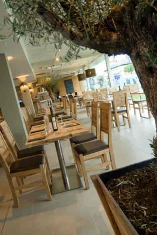 Modern dining space with wooden tables in Gusto Italian Cheadle Hulme for events.