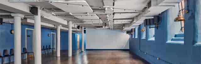 Modern boardroom with blue walls, perfect for meetings and workshops at Whitworth Locke.