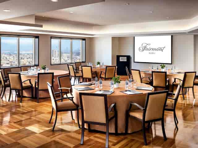 Meeting room at Fairmont Dubai Opera with circular seating and city views for corporate events.