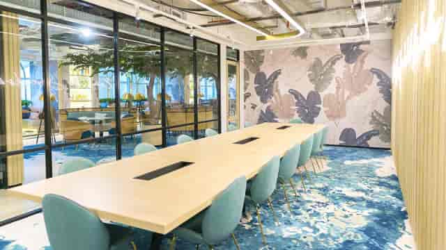 Modern GoWork meeting space with large wood table for brainstorming sessions.