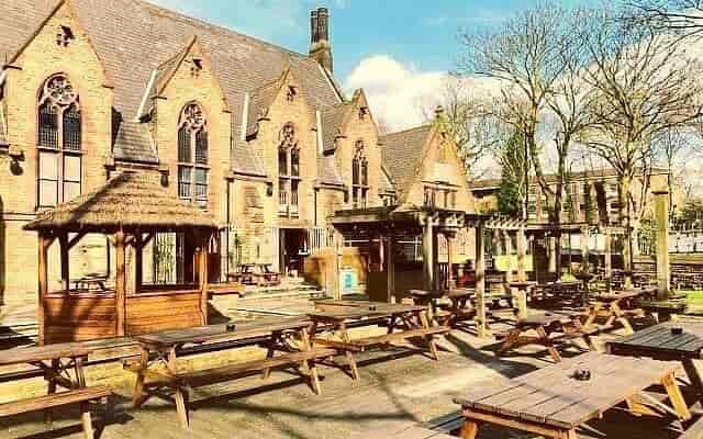 Charming outdoor bar with rustic tables, ideal for summer parties and events.