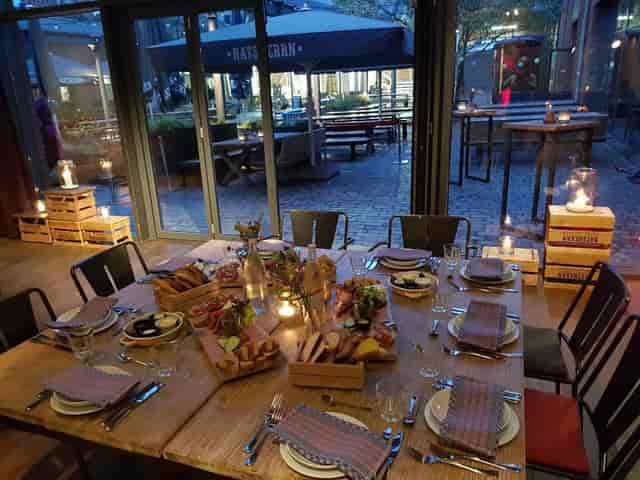 Intimate dining setup at Altes Mädchen, featuring rustic tables and floral centerpieces.