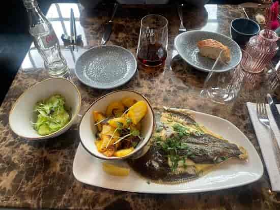 Elegant whole fish dish at Blue Mare Hamburg, perfect for corporate dining events.