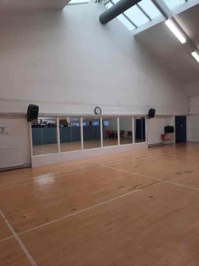 Versatile event space with mirrors in Colombo Sports & Community Centre for workshops and fitness.