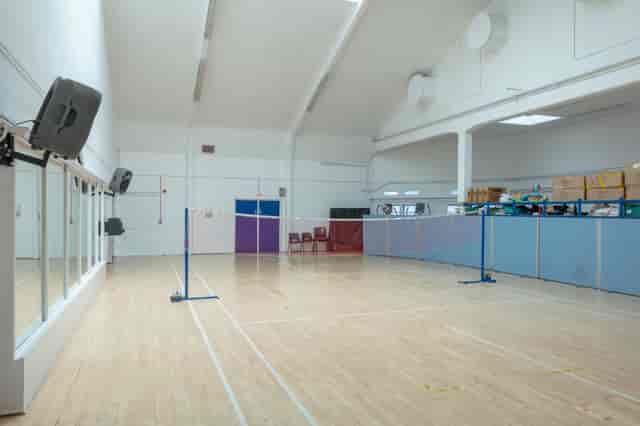 Versatile indoor event space in Colombo with natural light and badminton nets.
