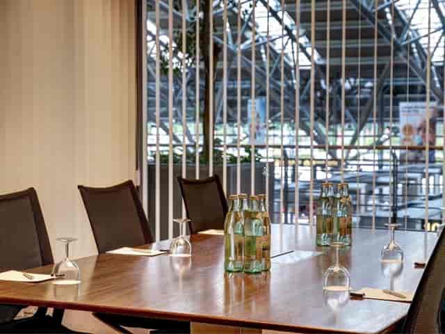 Modern meeting room at Hamburg Airport, featuring elegant wooden table for corporate events.