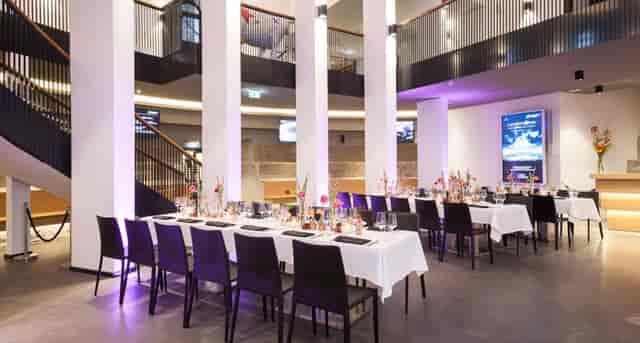Café Schmidtchen event space in Hamburg, set for upscale dinner with elegant décor.