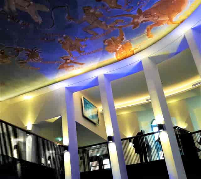 Vibrant Planetarium Hamburg foyer with celestial ceiling, ideal for events and gatherings.