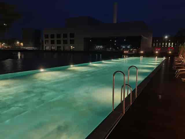 Illuminated pool area at The Ritz-Carlton, Wolfsburg for stylish evening events.
