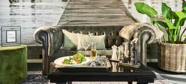 Stylish conference room in Designhotel ÜberFluss with plush sofa, perfect for meetings and events.