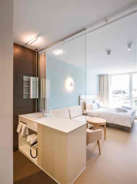 Modern hotel meeting room with glass partition, ideal for brainstorming and retreats.
