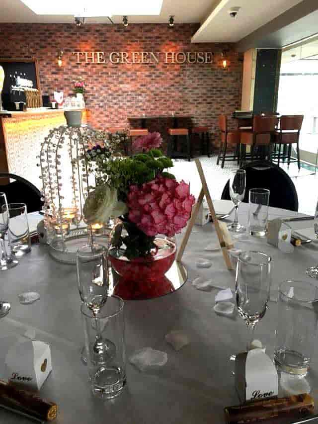Elegant table setting with floral centerpiece at Greenhouse Function Room bar & grill event.