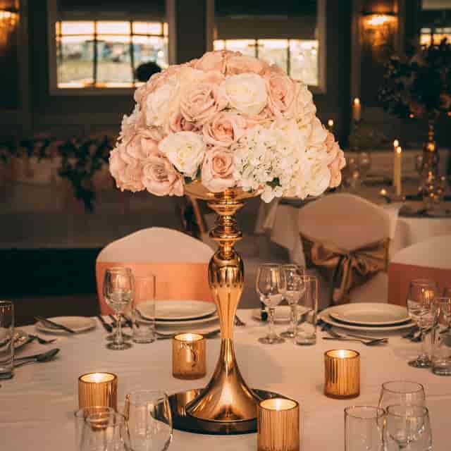 Elegant wedding table setting with pink flowers and candlelight at Parkview Hotel.