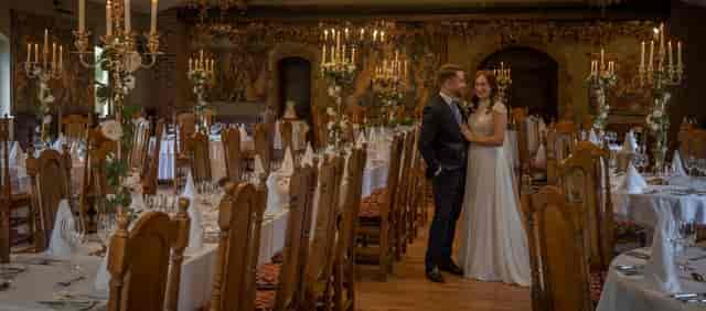 Medieval Hall in Barberstown Castle, elegant wedding banquet setup with floral decor.