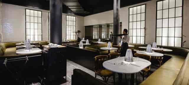 Stylish restaurant interior with soft lighting for intimate gatherings and corporate dinners.