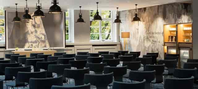 Renaissance Hamburg Hotel meeting room with modern chairs, ideal for corporate events.
