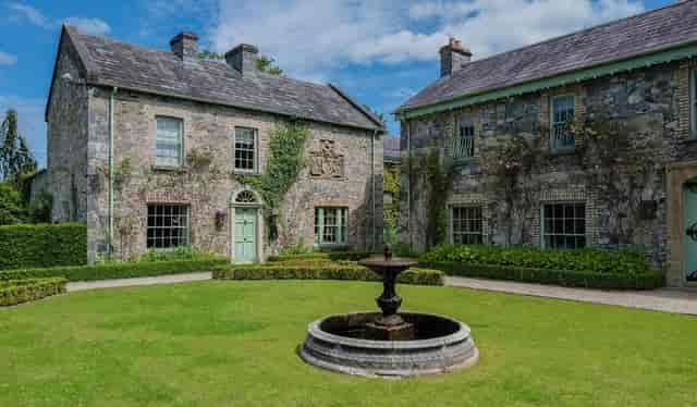 Charming Orangery venue with stone architecture for intimate outdoor events and receptions.