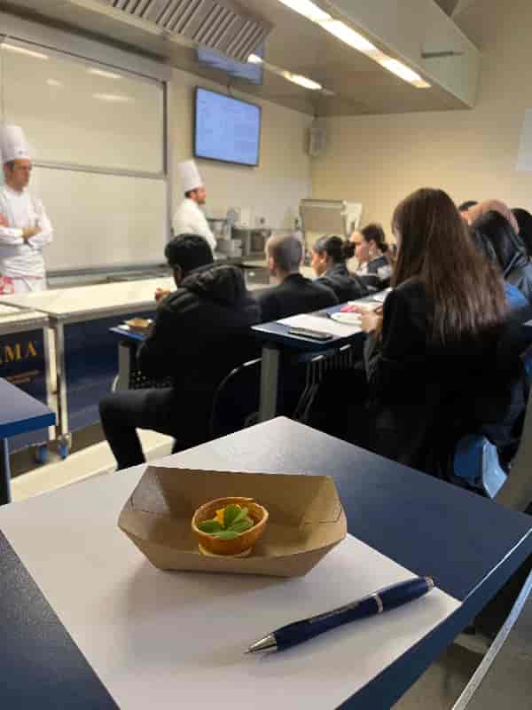 Culinary demo classroom: tiered seating, chef presentation.